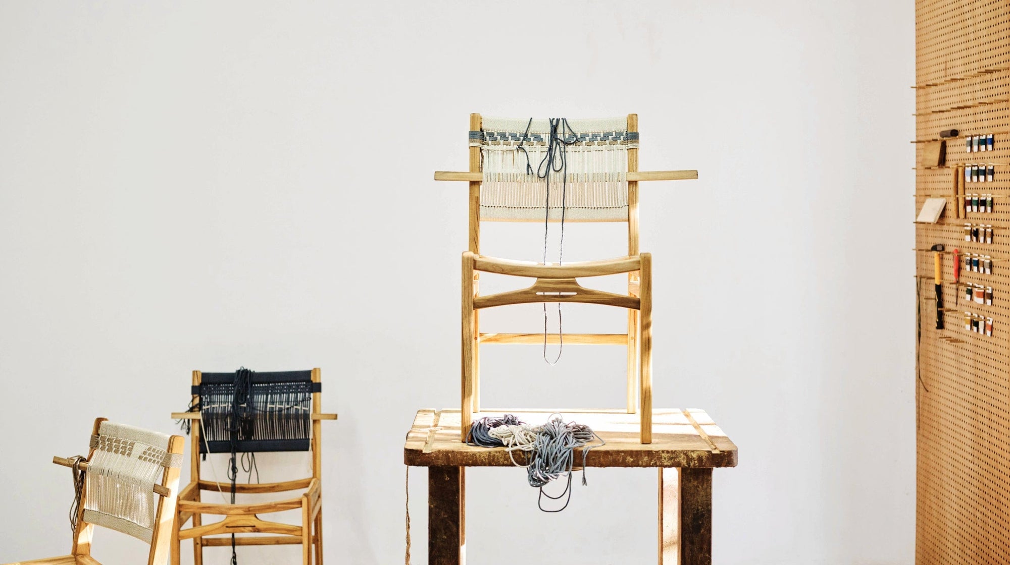 Woven strap teak dining chair with wooden frame in the MasayaCo workshop
